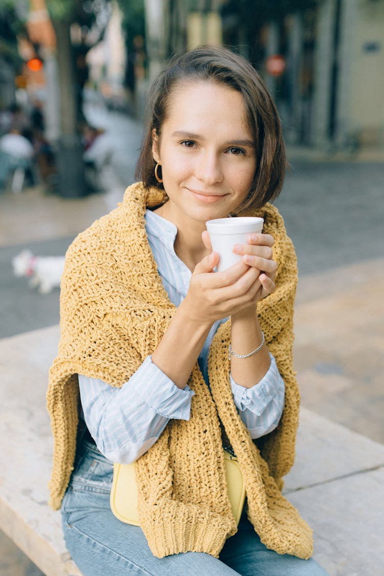 A Young Woman Holding A Styrofoam Cup