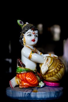Vivid close-up of a vibrant porcelain Krishna figurine highlighting intricate design and color.