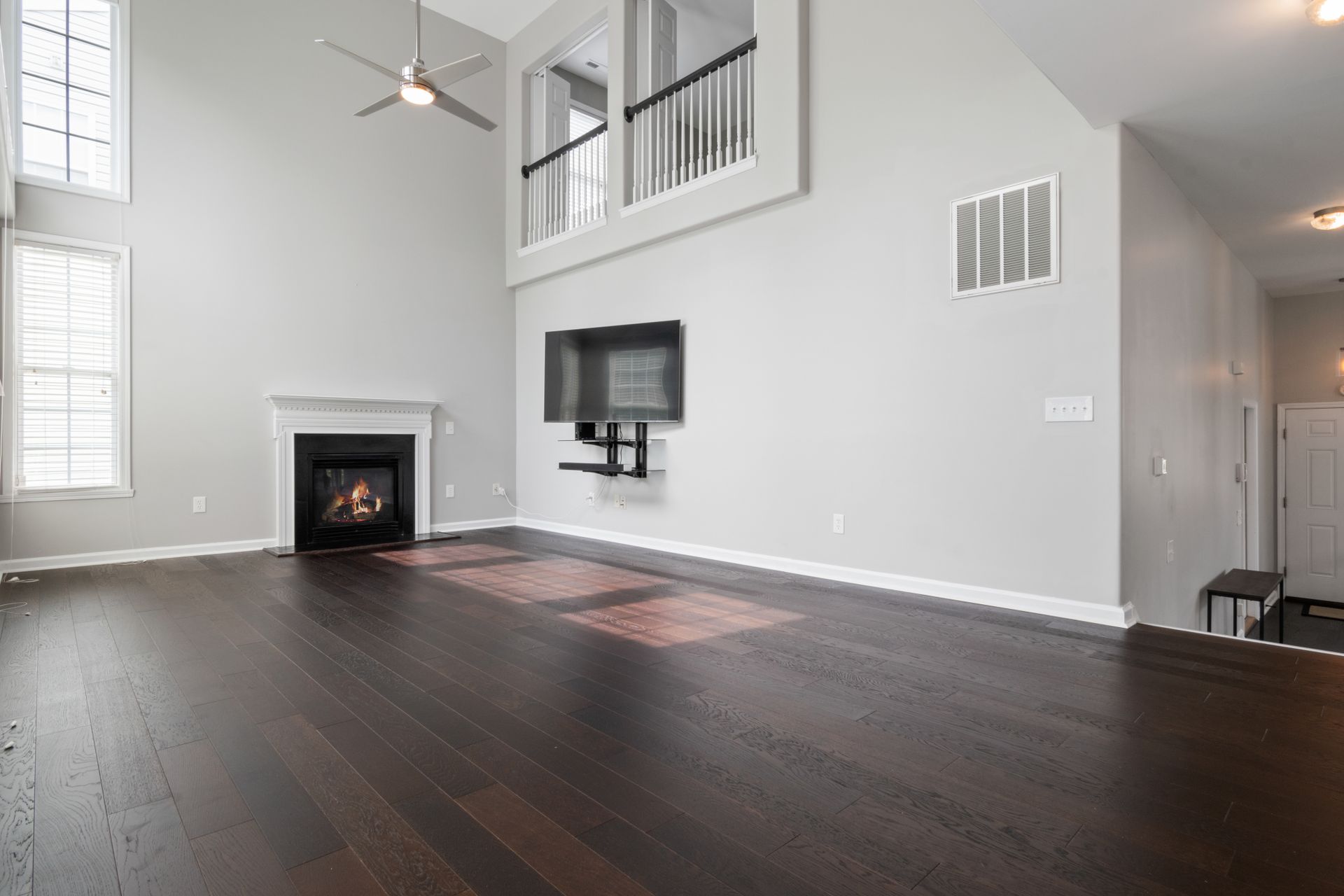 Bright and modern living room featuring a fireplace and mounted TV, perfect for contemporary homes.