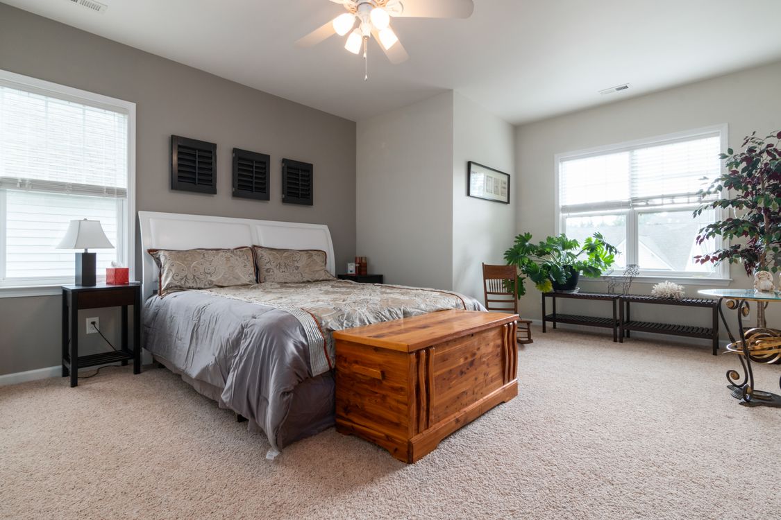 Brown Wooden Bed Frame With White Bed Linen