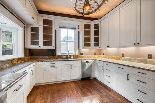 Spacious, modern kitchen featuring granite countertops, wood flooring, and elegant cabinetry.