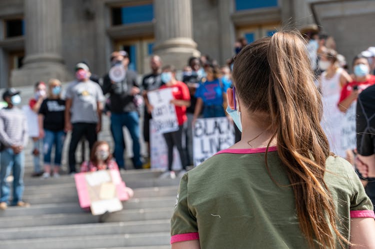 Unrecognizable Woman Taking Part In Protest