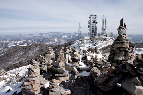 Free Communication system consisting of radio masts and telecommunication towers located on top of rocky highlands Stock Photo