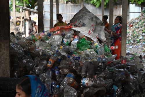 Free Workers sorting plastic bottles for recycling in Chattogram, Bangladesh Stock Photo