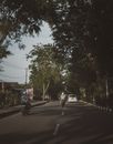 Man in Black Jacket Riding Bicycle on Road