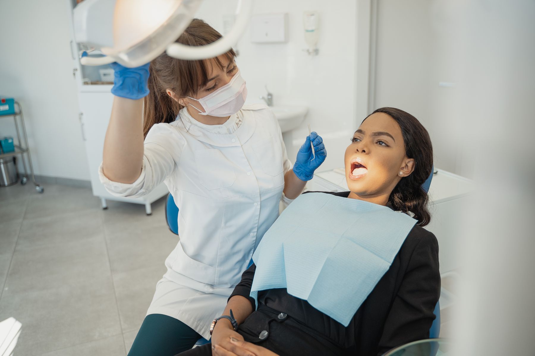 Smiling dental patient and clinician in a bright modern private dental clinic