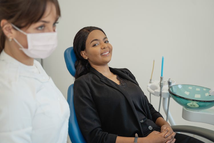 Woman In Black Blazer Sitting On Dental Chair