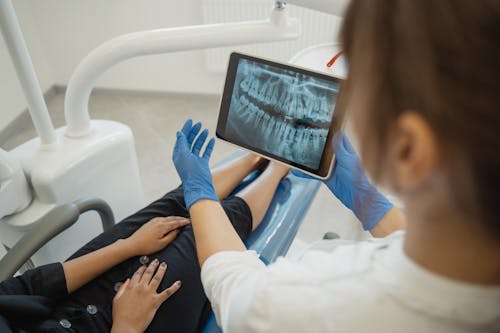 Free A Dentist Showing a Dental X-ray Stock Photo