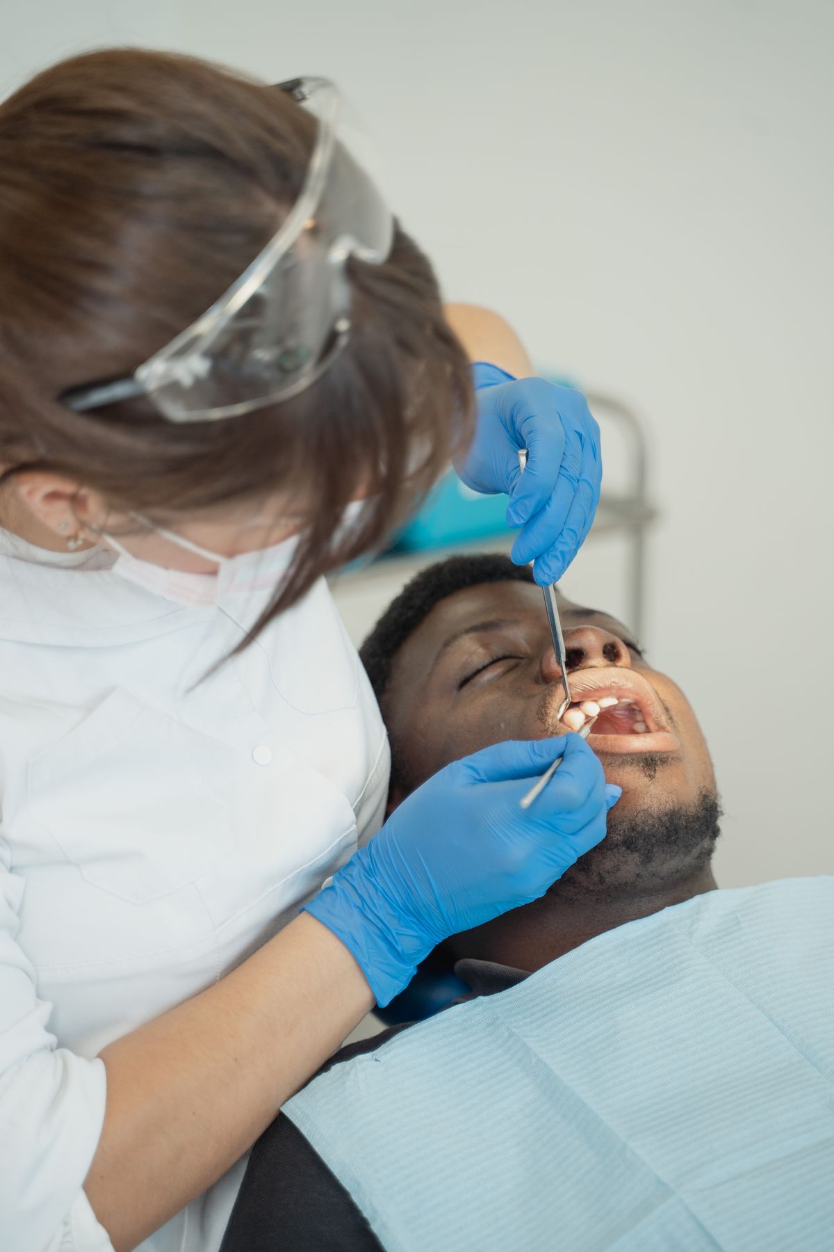 Dentist examining a patient in a clinical setting
