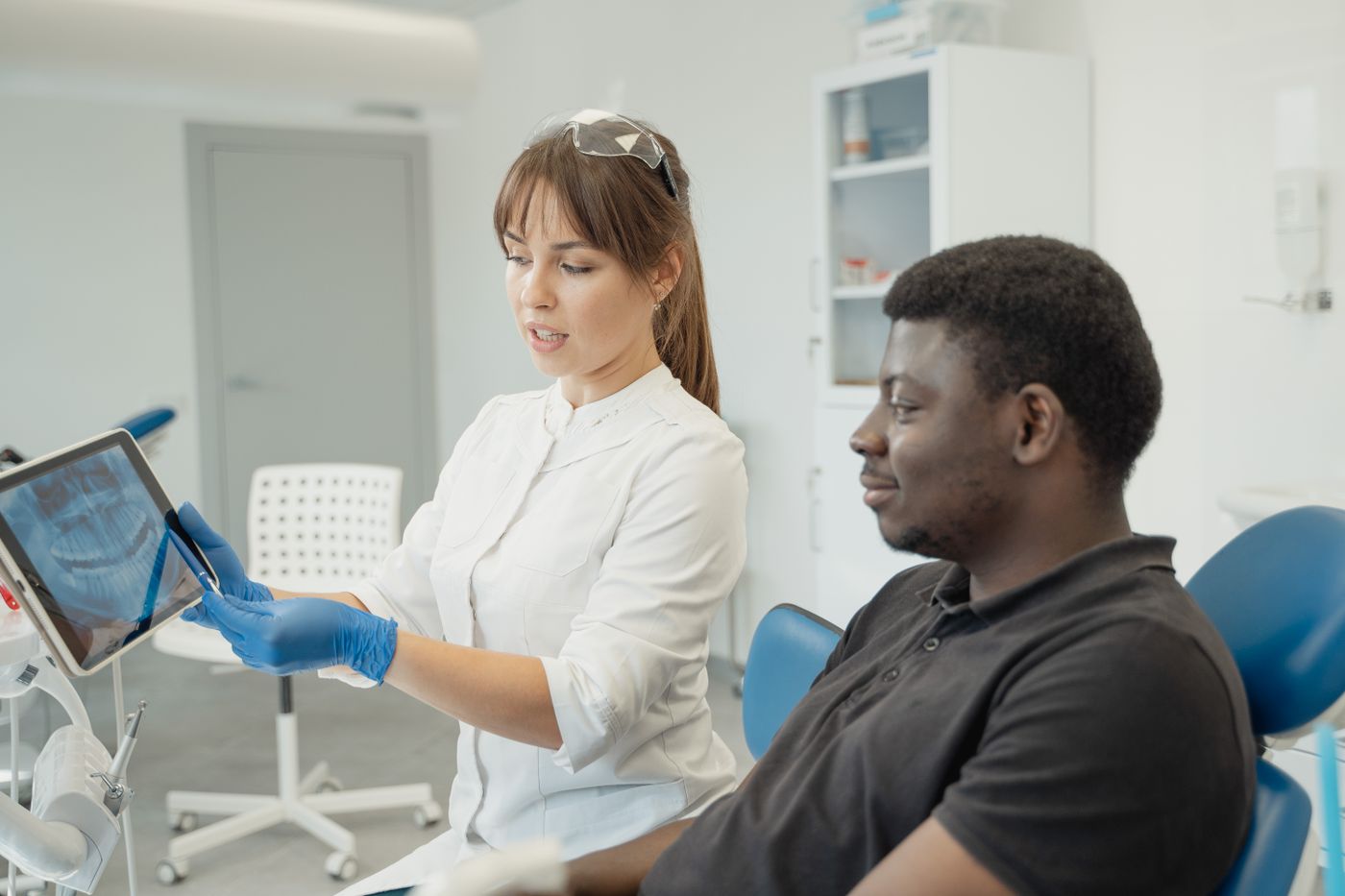 Dentist and patient reviewing dental imaging during a consultation