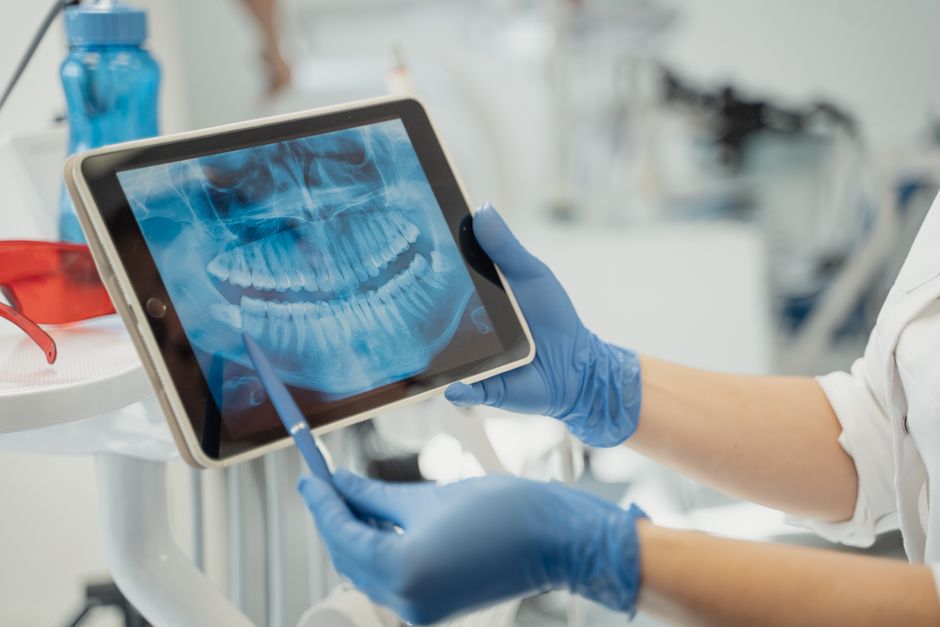 Dr. Wadie reviewing a digital design on a tablet chairside