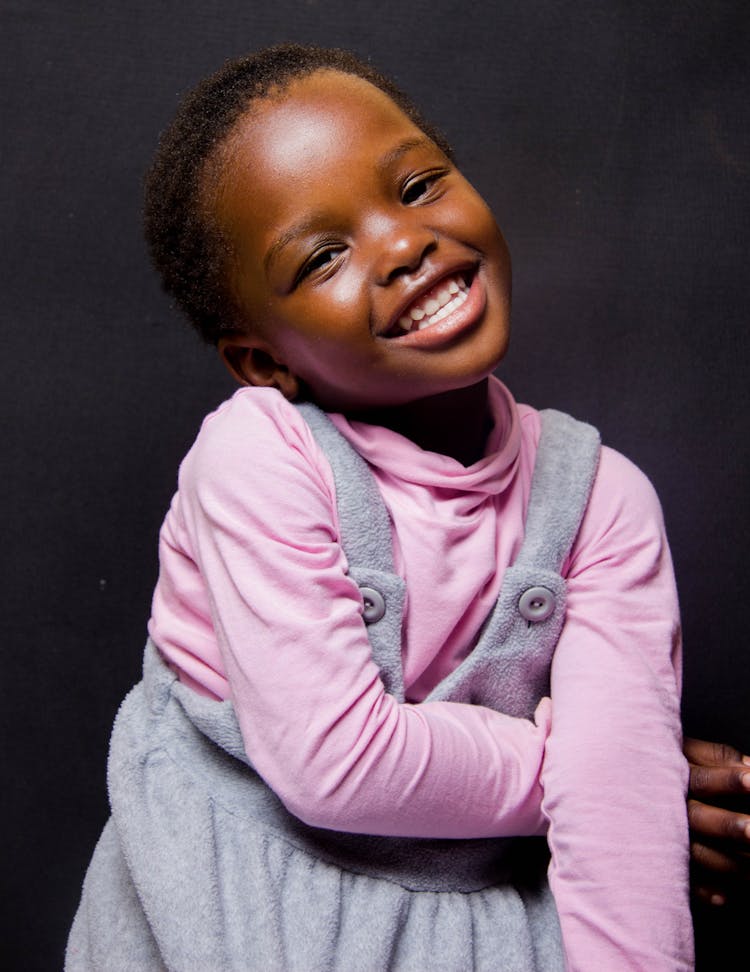 Girl In Pink And Gray Overalls Smiling 