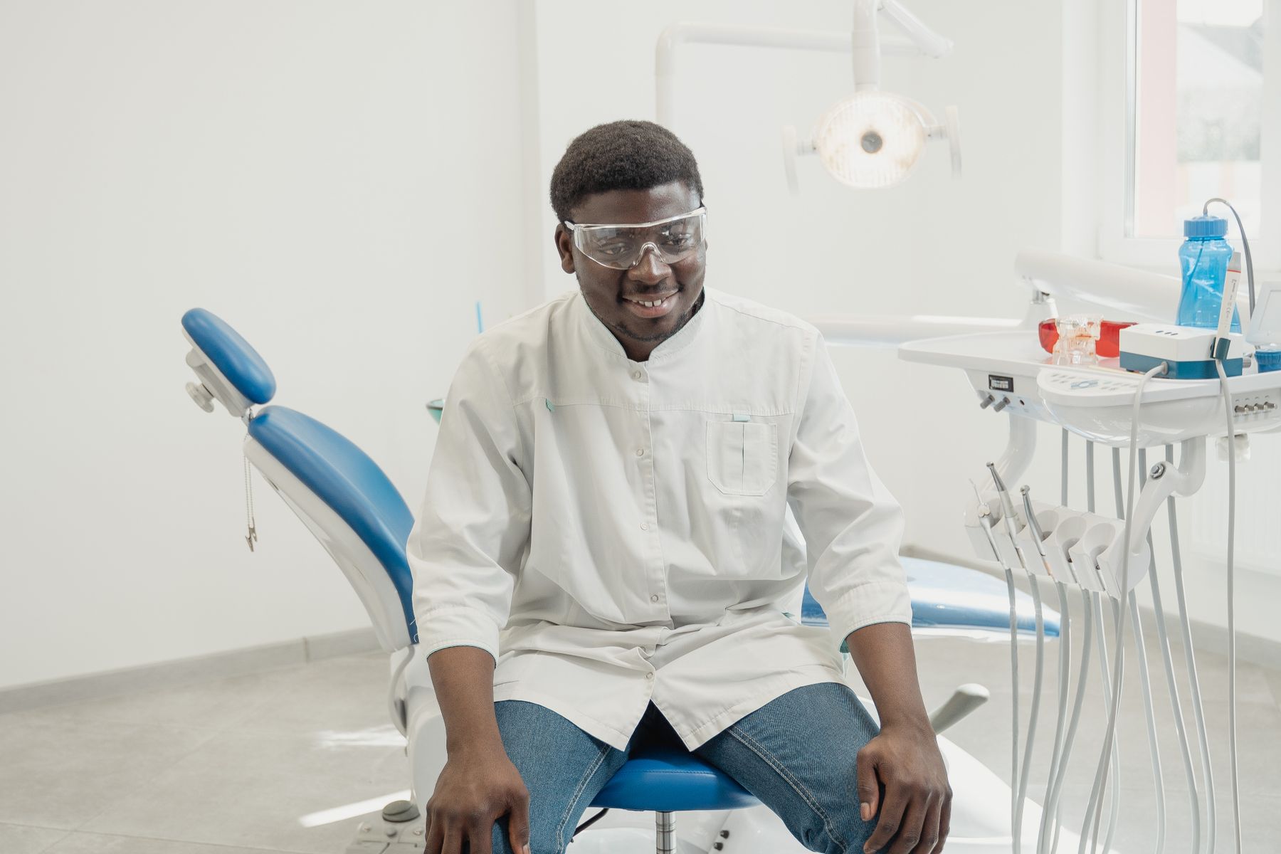 Smiling dental patient and clinician in a bright modern private dental clinic