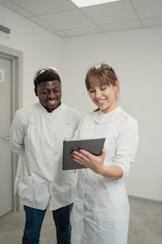Medical professionals in a hospital setting collaborating with a digital tablet.