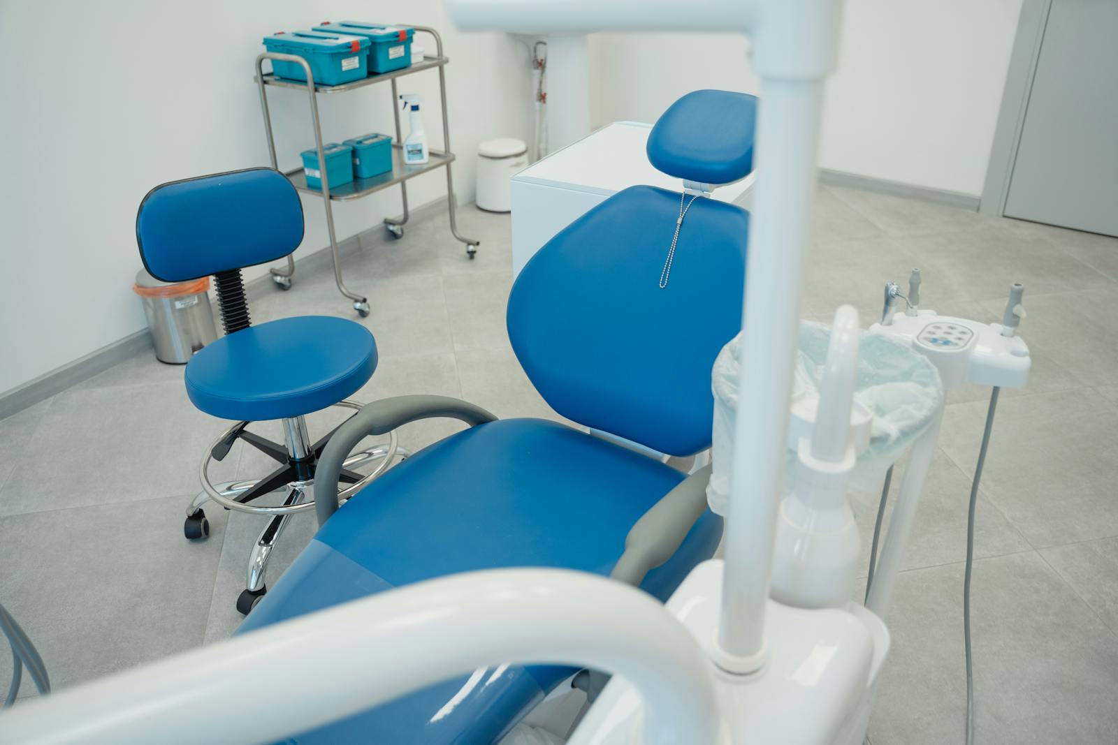 Modern dental clinic with blue chairs and dental equipment