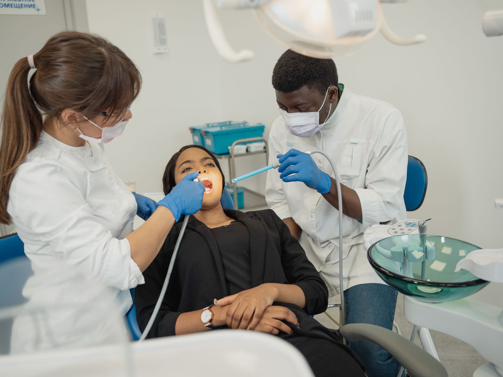 Smiling dental patient and clinician in a bright modern private dental clinic