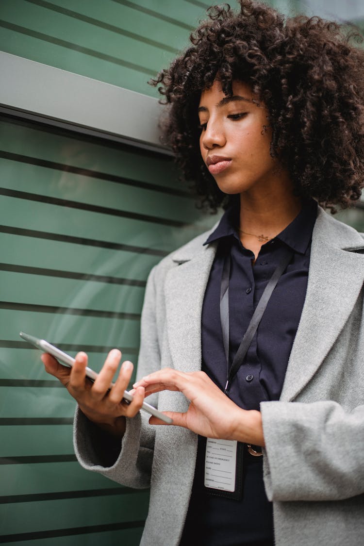 Crop Attentive Black Female Worker Browsing Internet On Tablet