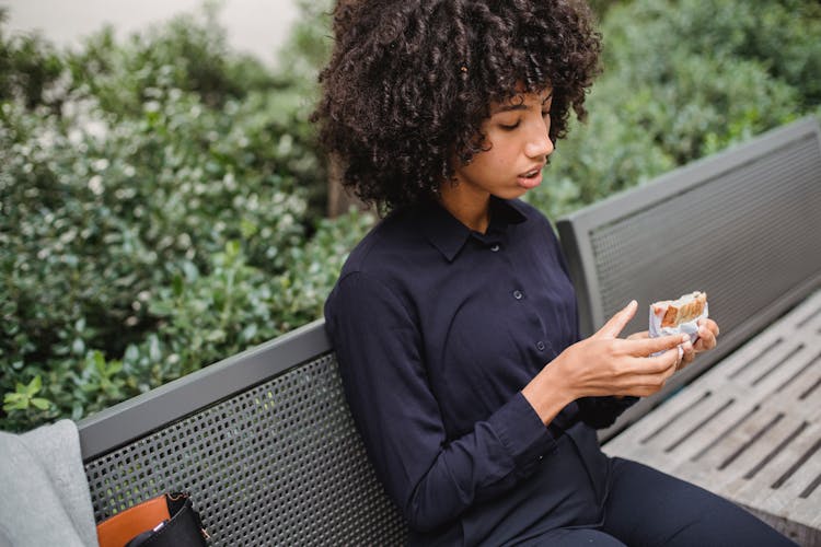 Crop African American Woman Having Snack