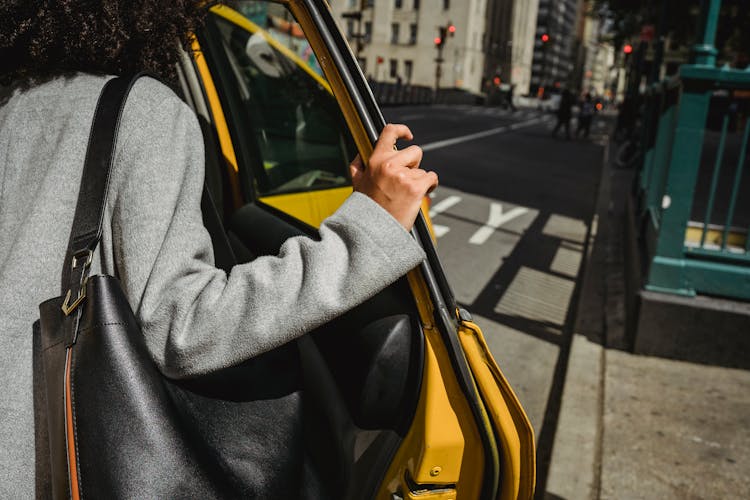 Crop Ethnic Woman Opening Door Of Taxi