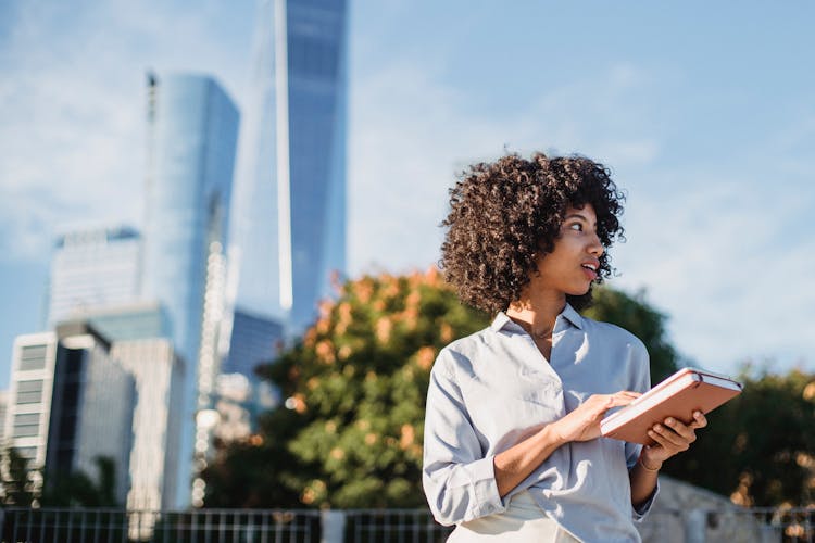 Black Woman With Tablet On Street