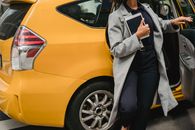 Crop ethnic woman getting out of car