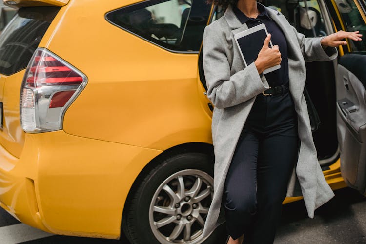 Crop Ethnic Woman Getting Out Of Car