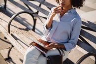Woman in Blue Dress Shirt Sitting on Bench