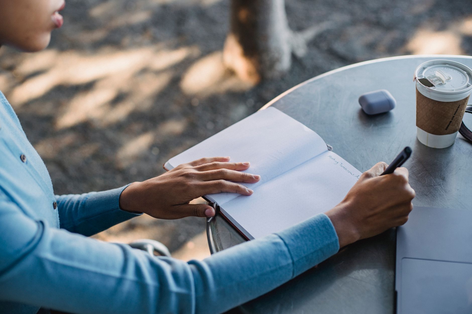 ADHD decision making decision paralysis executive function — woman journaling notebook coffee shop afternoon light contemplative