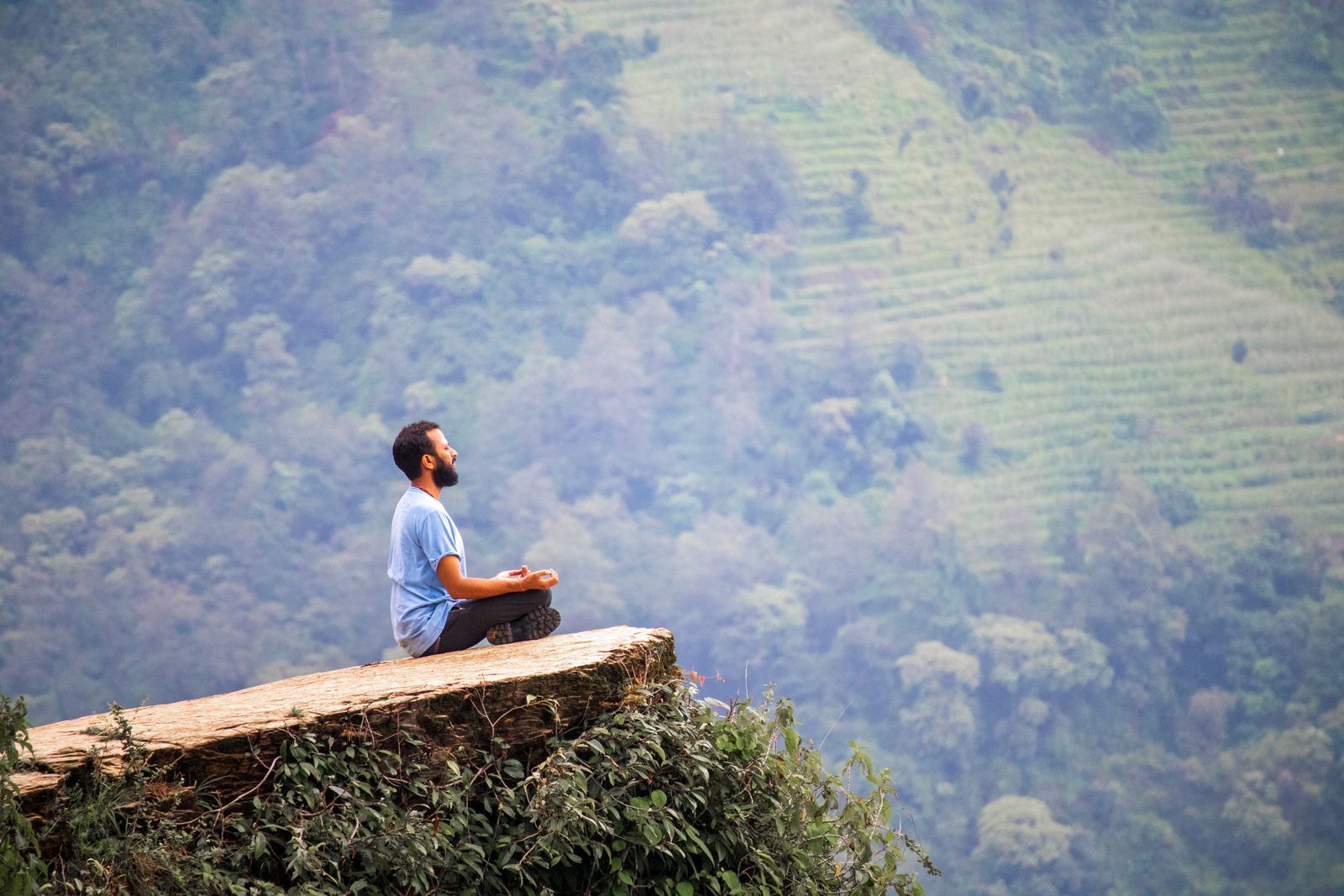 Woman practicing seated meditation posture as part of raja yoga mental discipline