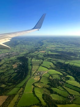 Scenic aerial view of sprawling English countryside from an airplane window on a clear day.