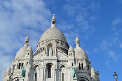 Gray and White Cathedral Under Cloudy Blue Sky