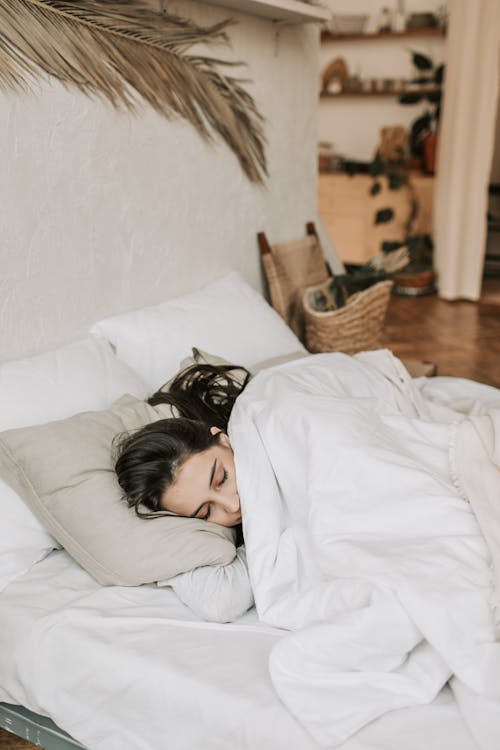 Free Woman Sleeping on a Bed With White Blanket Stock Photo
