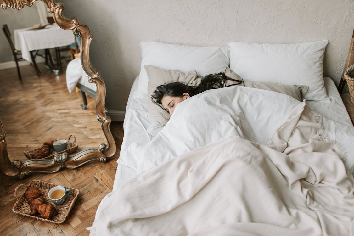 Free A Woman Sleeping on Bed Stock Photo