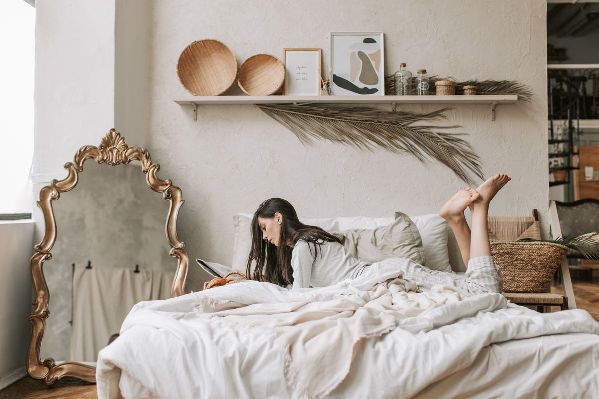 Full length mirror safely styled beside a bedroom bed