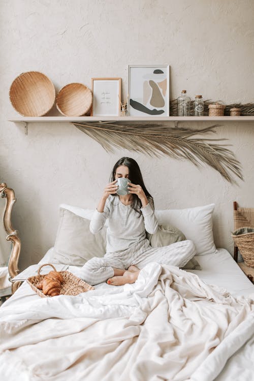 Free A Woman Having Her Breakfast in Bed Stock Photo