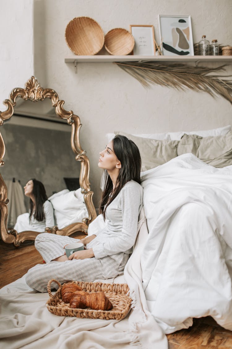 A Woman Sitting On The Bedroom Floor