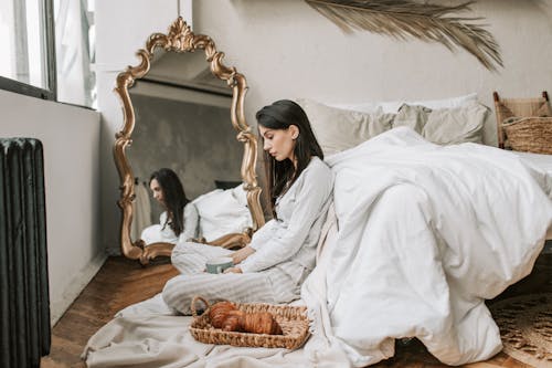 Free A Woman Sitting on the Bedroom Floor Stock Photo