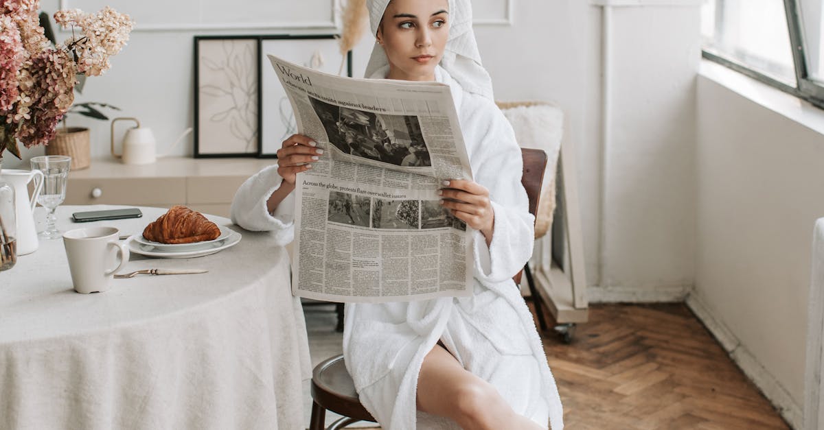 Woman in Bathrobe Reading Newspaper