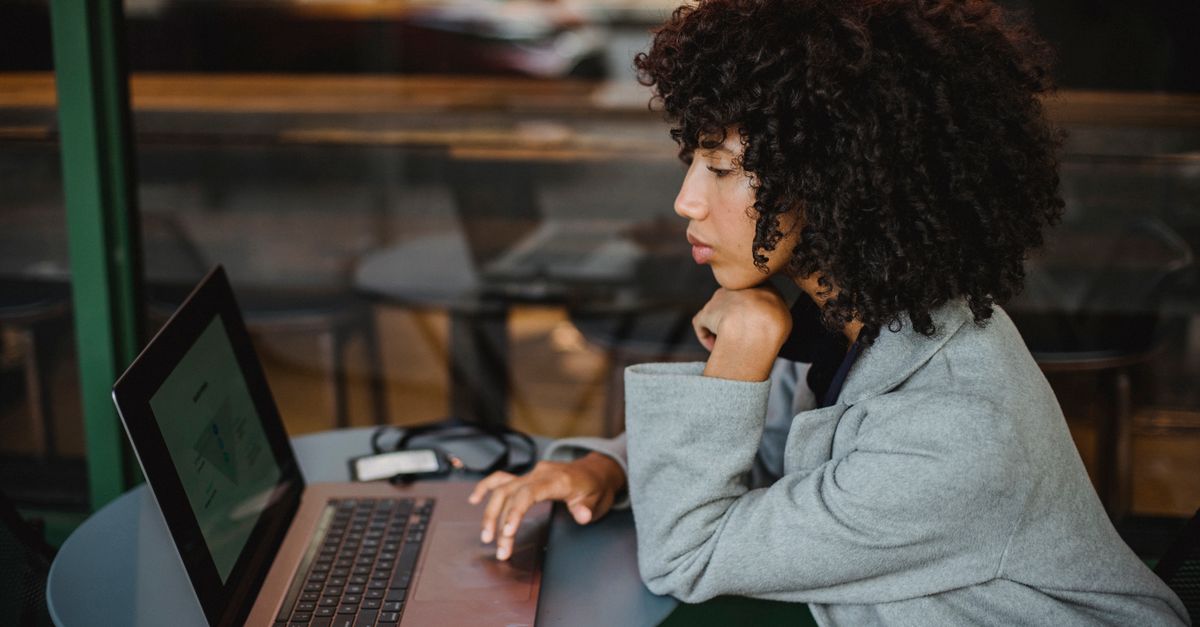 small business owner working on laptop in coffee shop