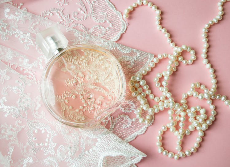 Clear Round Glass Bottle On White Lace