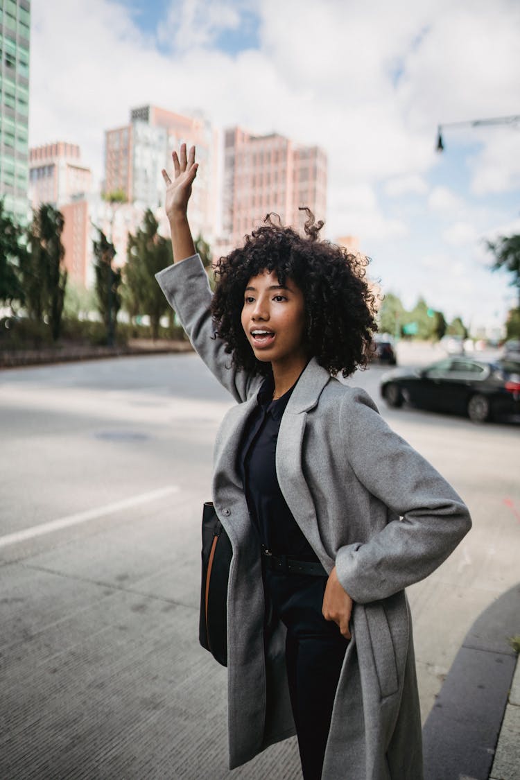 Woman In Gray Coat Waving