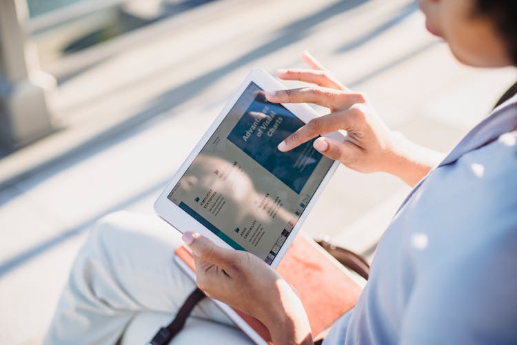 Person Holding White Tablet