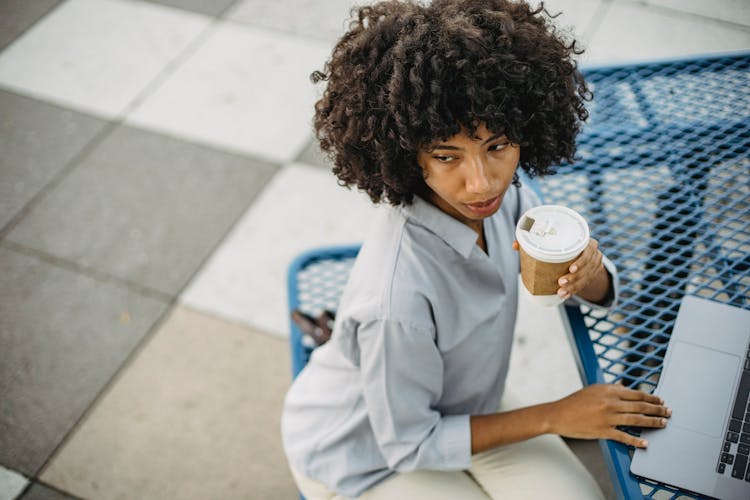 Woman Holding White Disposable Coffee Cup