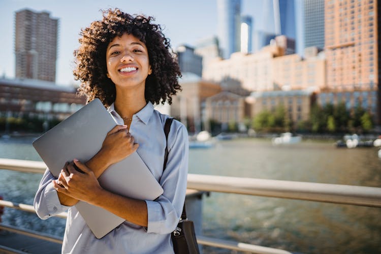 Woman Holding Silver Laptop