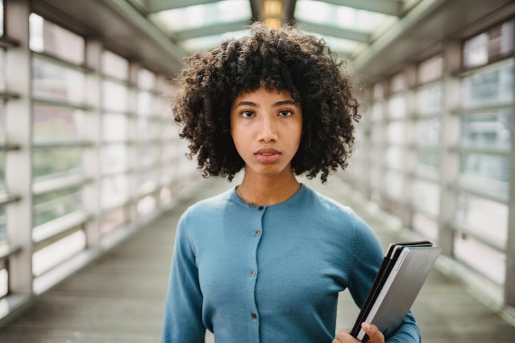 Woman In Blue Long Sleeve Shirt With Curly Hair