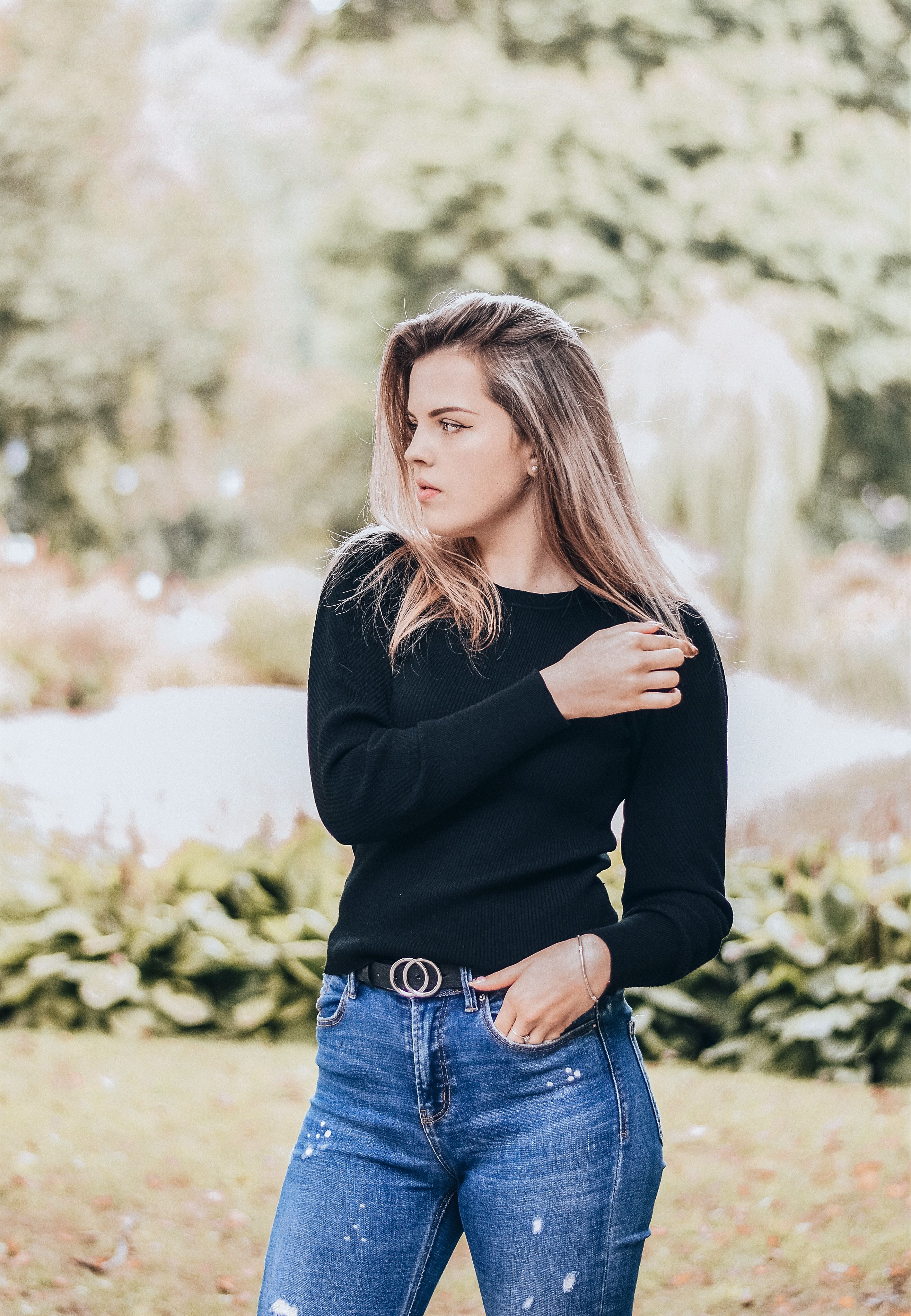 A Woman in a Black Long Sleeves and Denim Jeans · Free Stock Photo
