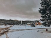 Brown and White Concrete Building Near Trees Under White Clouds