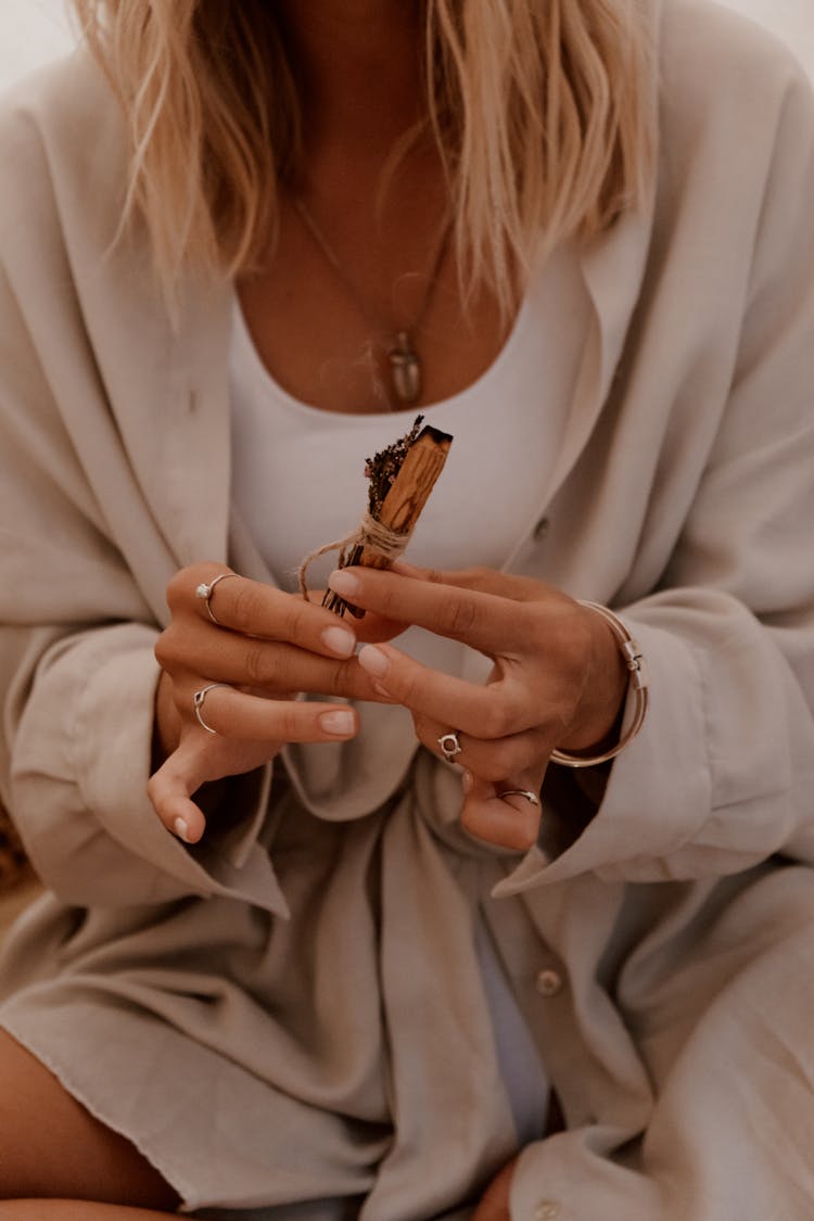 A Woman Holding A Palo Santo Stick