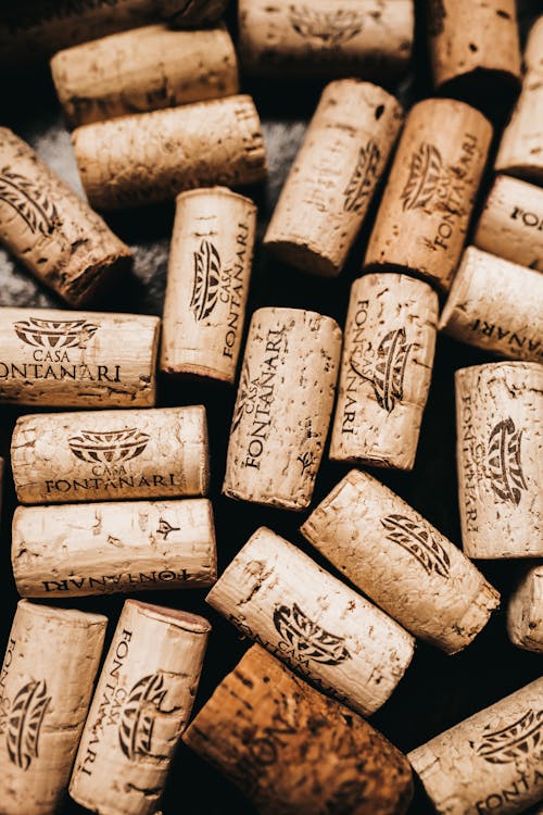 Free Top view of wine timber corks with logo and caption on black background Stock Photo