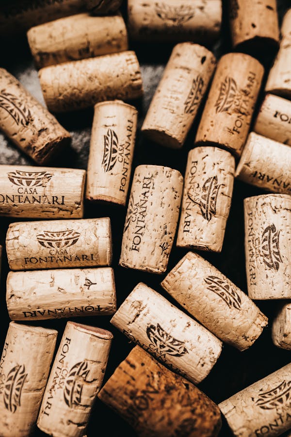 Top view of wine timber corks with logo and caption on black background